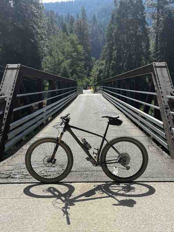 Gravel bike on a steel truss bridge in deep forest